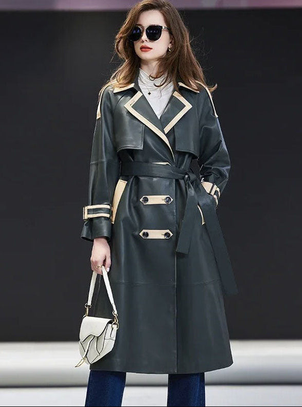 Women's Leather Outer Space Trench. Crafted from 100% sheepskin in a deep Outer Space hue, featuring a structured double-breasted front, contrast leather trim, decorative tabs, and a commanding silhouette. Borcelleclothes.