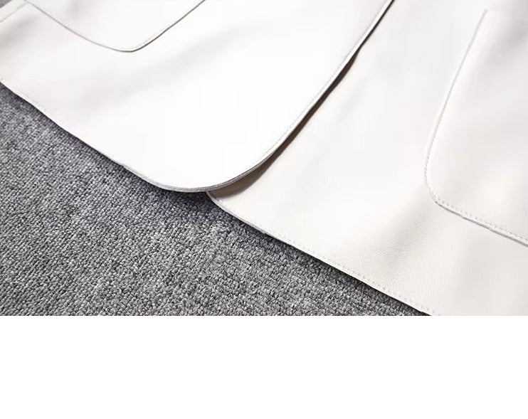 Women's Leather Wrap Vest in Magnolia. Close-up of the bottom front panels, showcasing the softly rounded edges that enhance the vest’s fluid structure. Borcelleclothes.