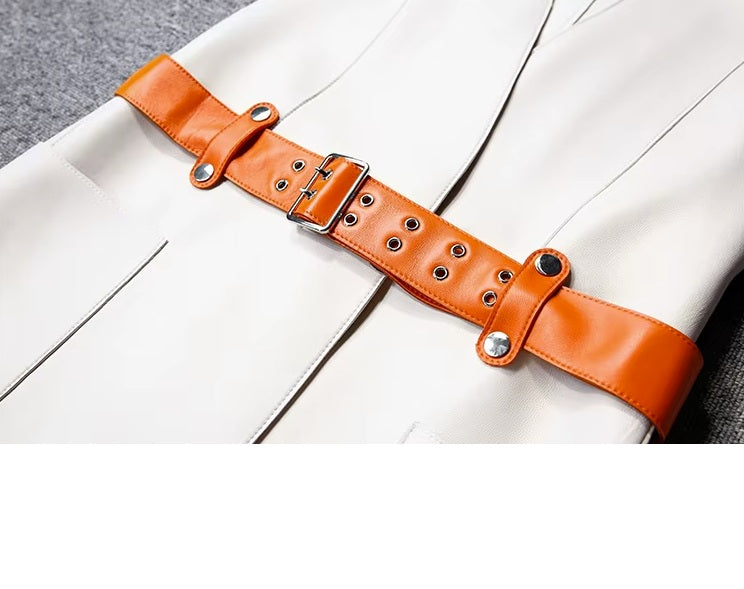 Women's Leather Wrap Vest in Magnolia. Close-up of the waist, featuring the fastened contrast orange belt that sculpts the silhouette with bold definition. Borcelleclothes.