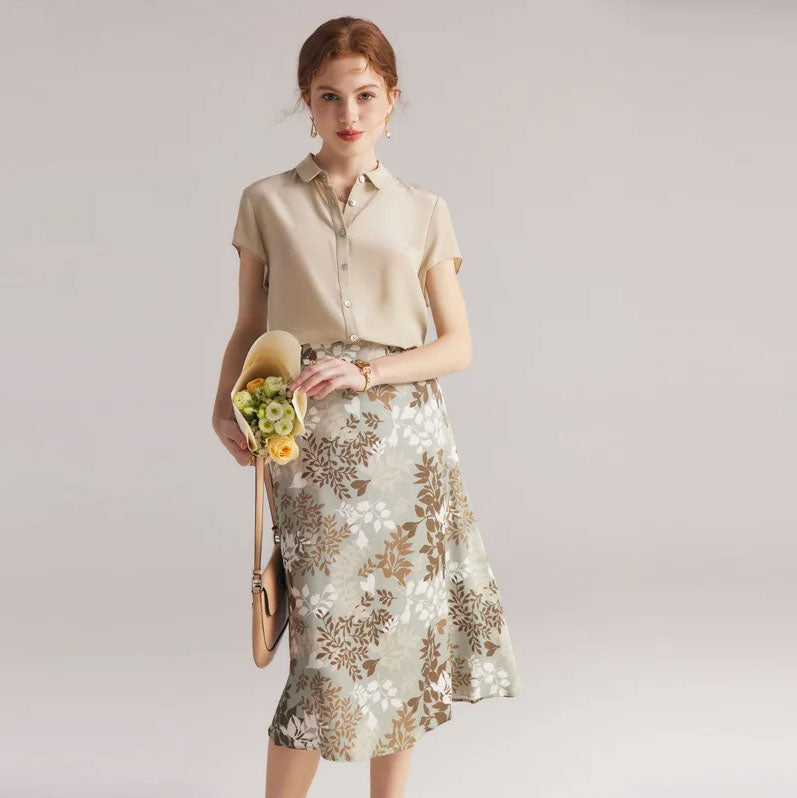 Model in Lemon Grass silk skirt holding flowers, emphasizing the skirt’s softness and composure. From Borcelleclothes.