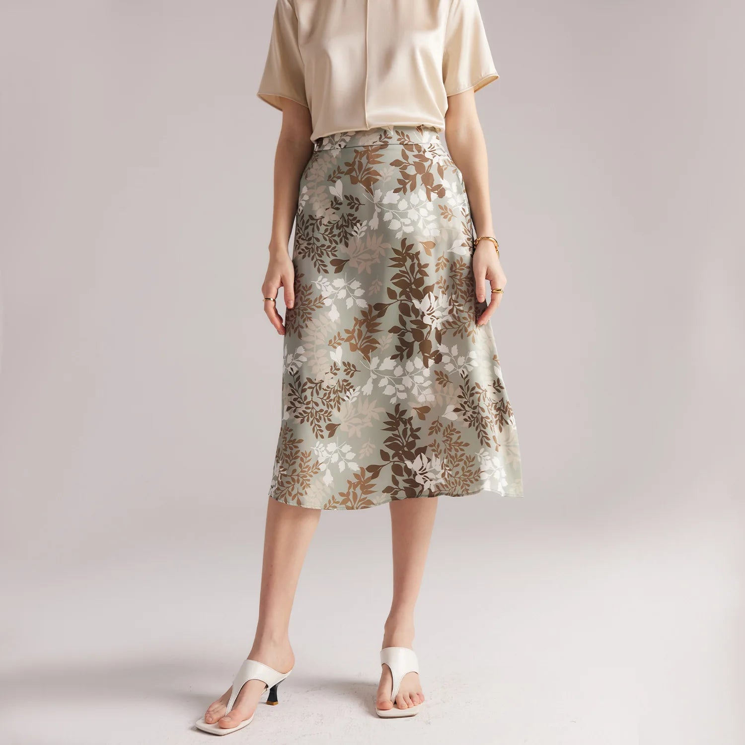 Model pairing Lemon Grass silk skirt with white sandals, showing full look in quiet, balanced styling. From Borcelleclothes.