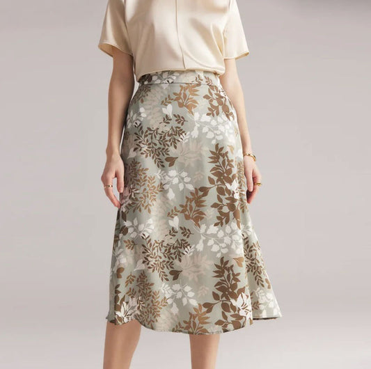 Women's mid-length A-line silk skirt in Lemon Grass with subtle leaf pattern, featuring discreet side pockets and invisible back zipper. From Borcelleclothes.