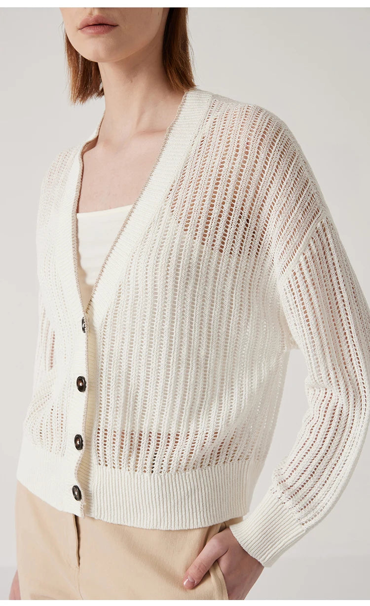 Model in Wild Sand cardigan with one hand in pants pocket, highlighting relaxed dropped shoulder and ribbed hem. From Borcelleclothes.