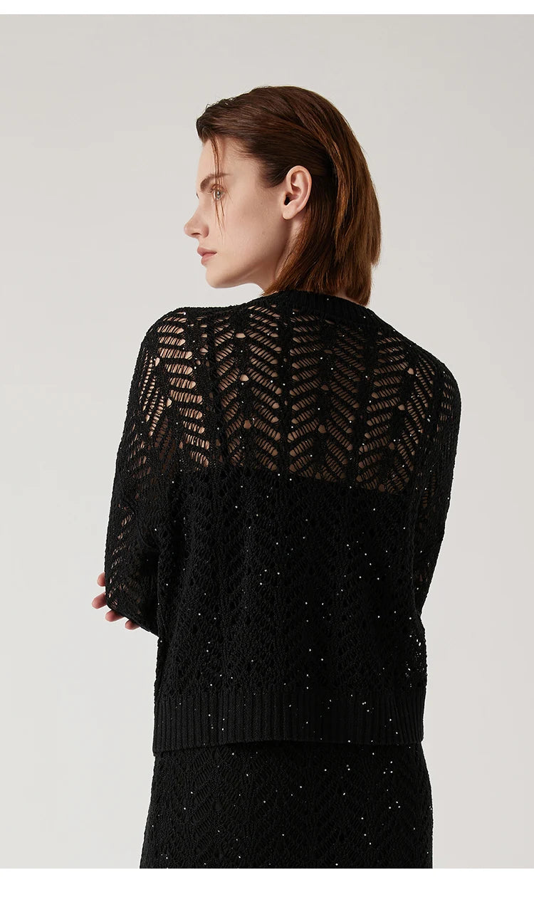 Back view of the Onyx linen lace cardigan, showcasing the curved lace neckline and ribbed hem. From Borcelleclothes.