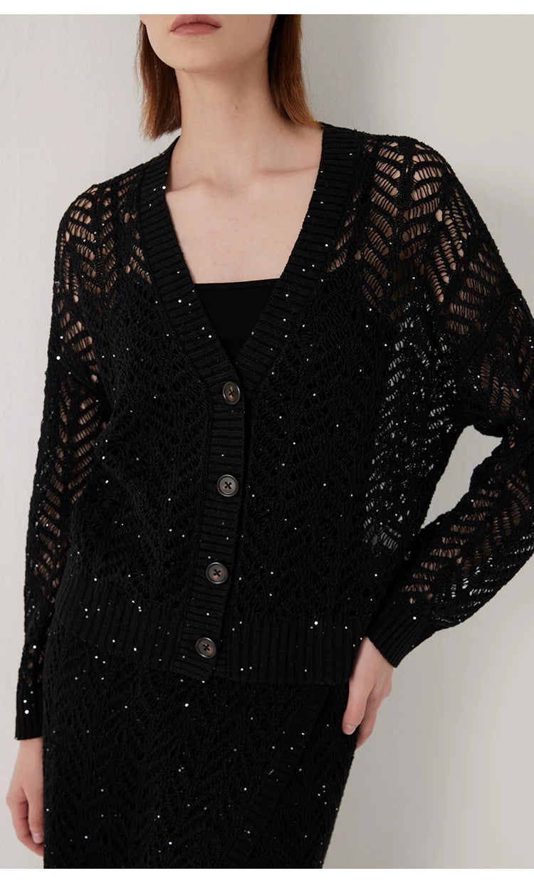 Onyx linen lace cardigan, model with one hand resting on hip, highlighting the ribbed cuff and hem. From Borcelleclothes.