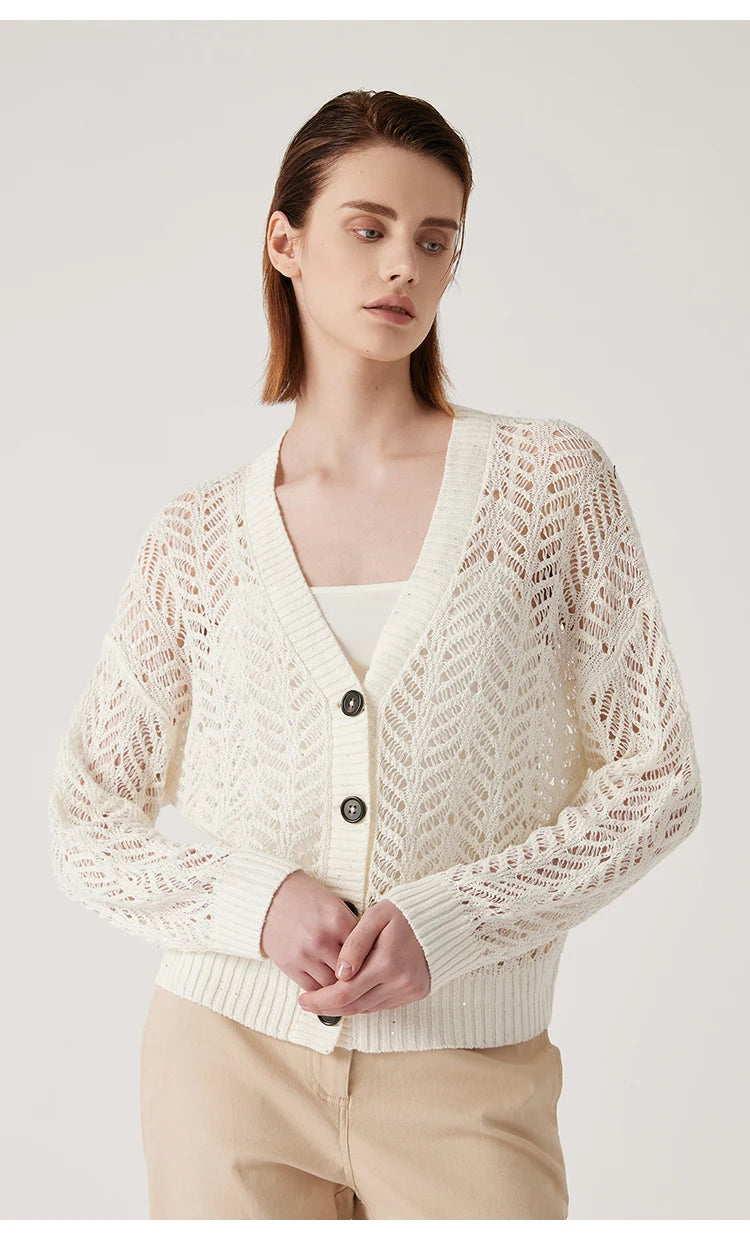 Model in Pearl Bush cardigan, looking to the side with soft natural light on the lace texture. From Borcelleclothes.