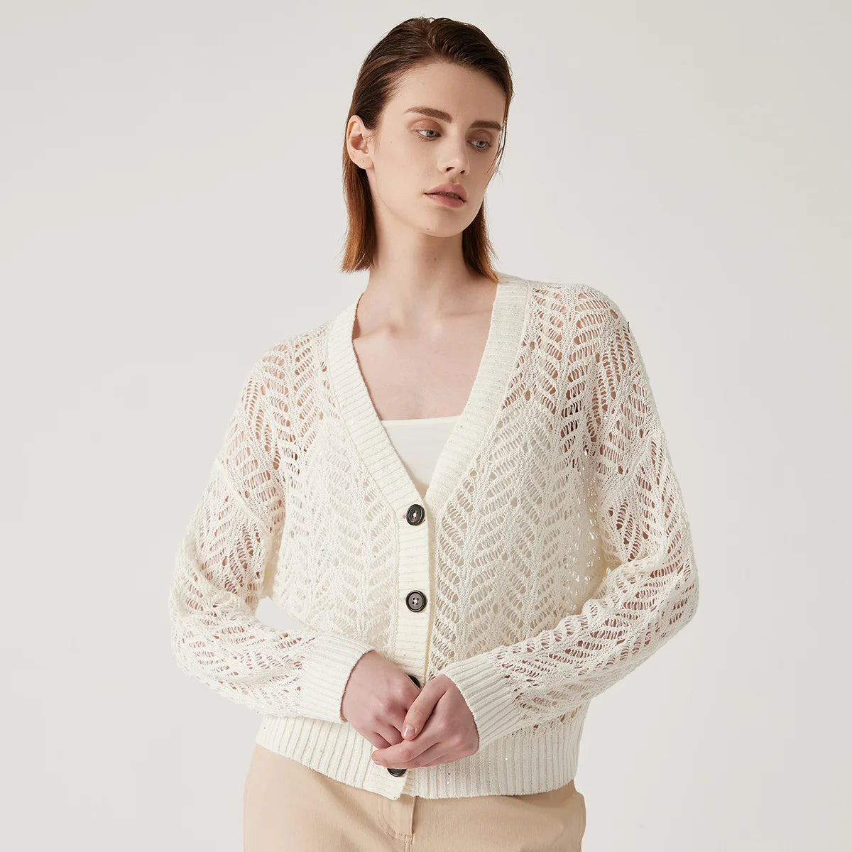 Women's linen lace cardigan in Pearl Bush, featuring a flowing openwork pattern, ribbed cuffs, and a wide hem for gentle structure. From Borcelleclothes.