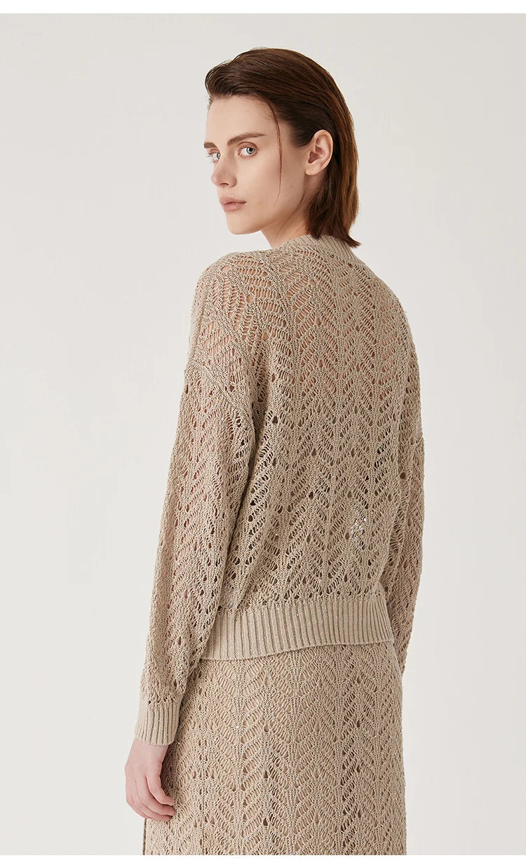 Back view of the Vanilla cardigan, with lace pattern gently tracing the spine. From Borcelleclothes.