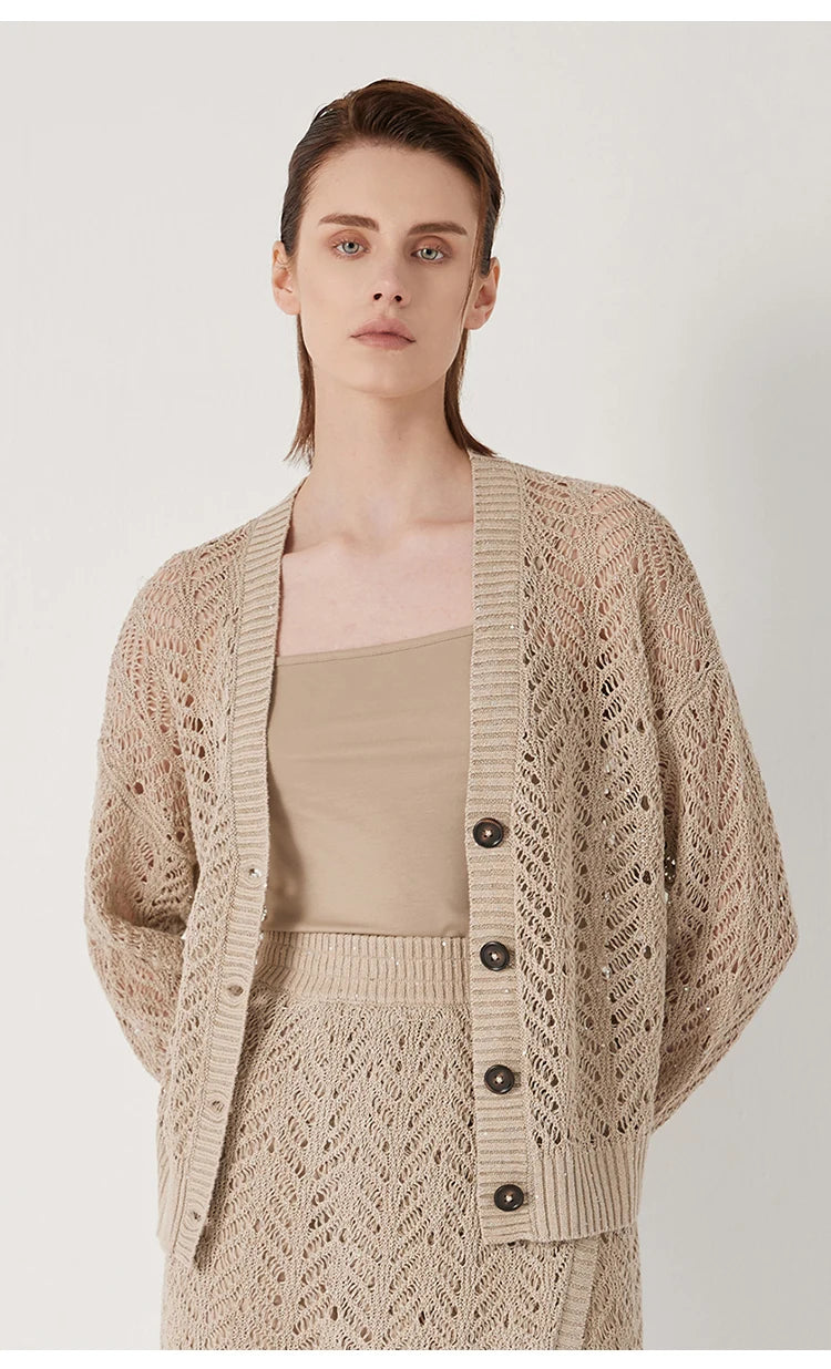 Model in Vanilla cardigan with hands held behind, conveying softness and quiet elegance. From Borcelleclothes.