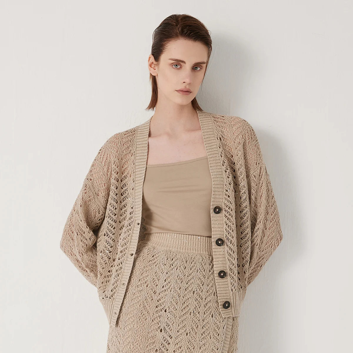 Women's linen lace cardigan in Vanilla, featuring a flowing openwork pattern, ribbed cuffs, and a wide hem for gentle structure. From Borcelleclothes.