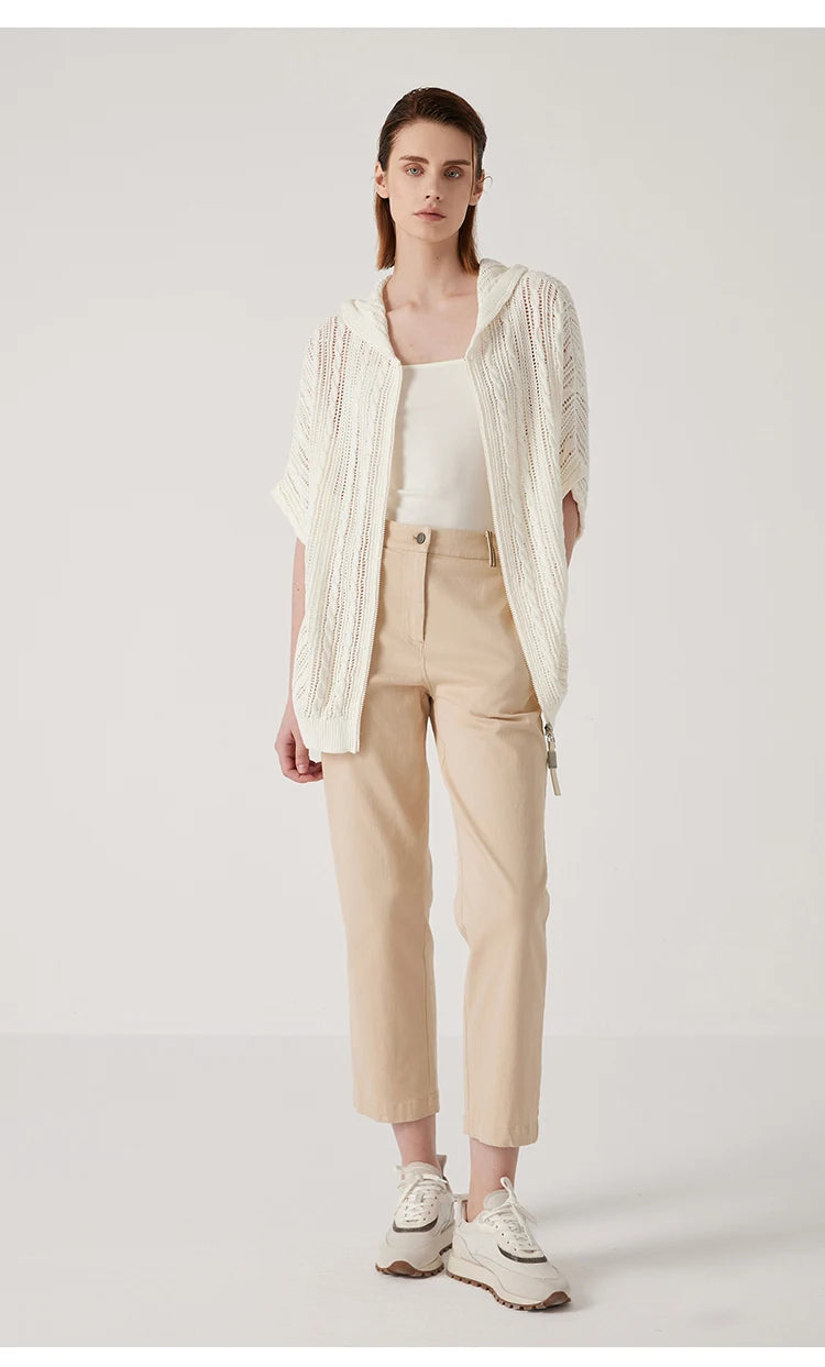 Full-body view of the pearl bush linen lace hoodie, paired with beige trousers to highlight its airy, sophisticated design. From Borcelleclothes.