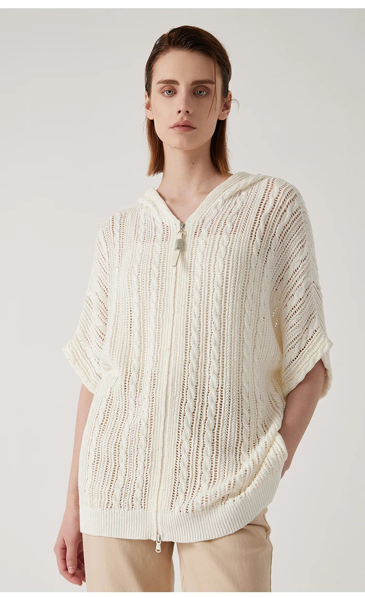 Front view of the pearl bush hoodie with the model’s hand behind her back, focusing on the front lace structure. From Borcelleclothes.