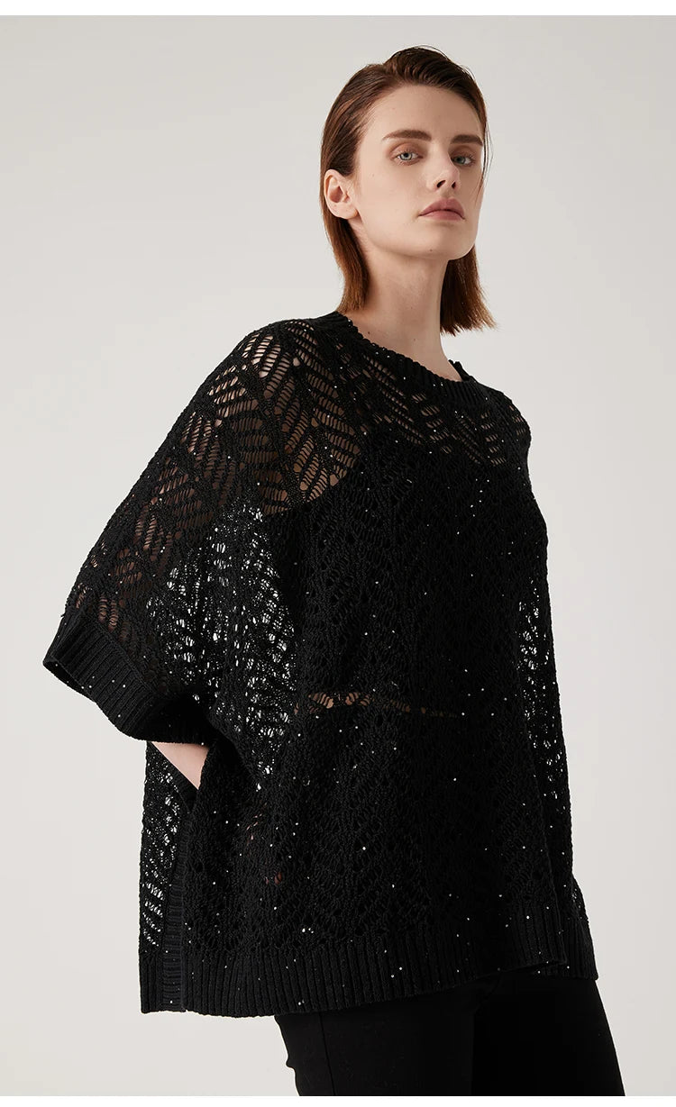 Side view of Onyx linen poncho, openwork lace hovering gently around the body in suspended form. From Borcelleclothes.