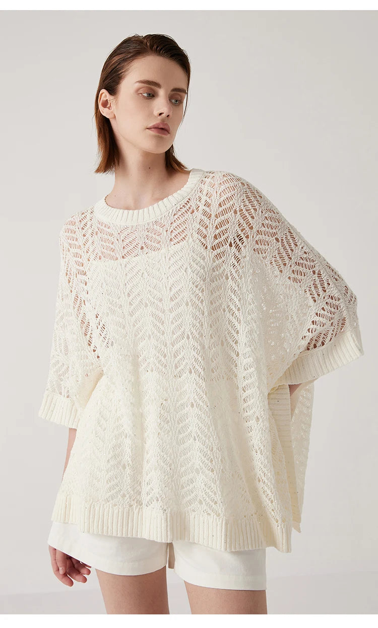 Close view of Pearl Bush linen poncho with hand on hip, highlighting the soft contrast between knit and skin. From Borcelleclothes.