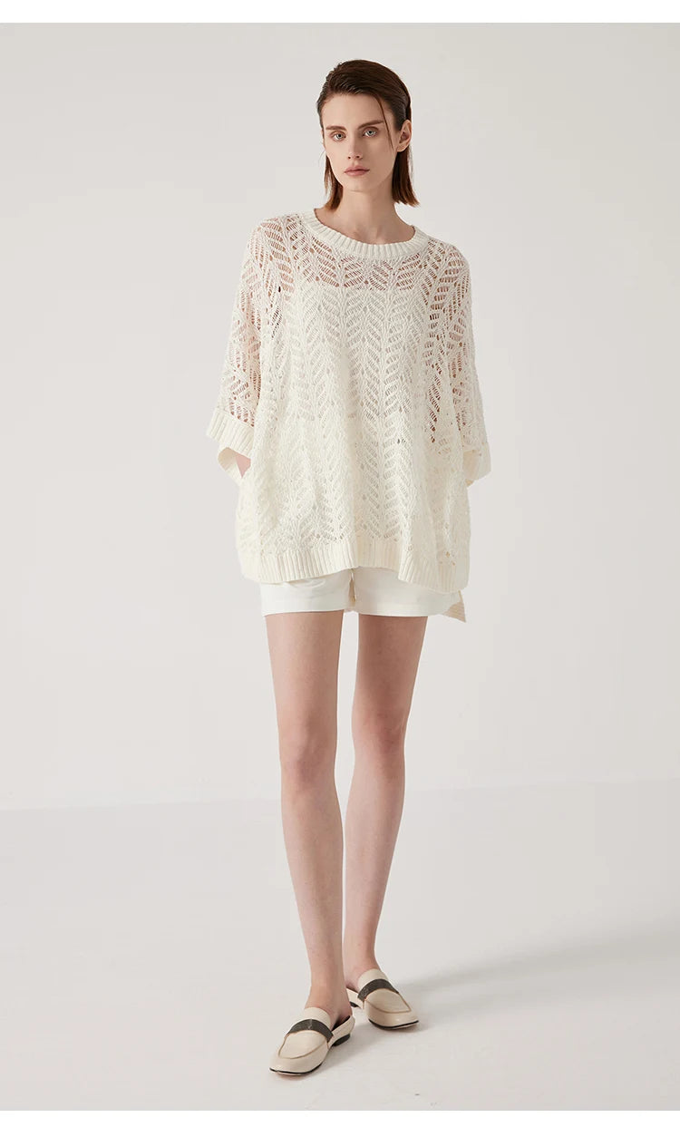Full-length shot of Pearl Bush linen lace poncho, luminous knit and rectangular silhouette radiating subtle calm. From Borcelleclothes.