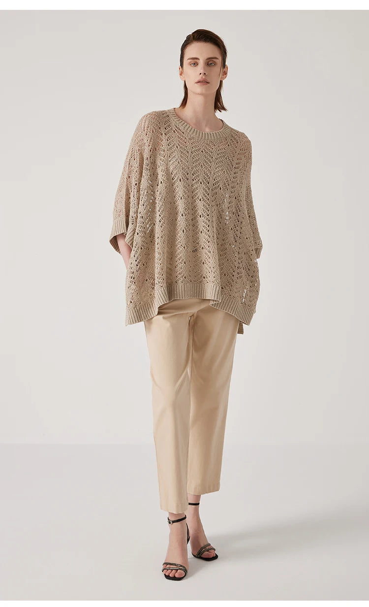 Full-length view of Vanilla poncho in linen lace, tranquil silhouette and soft cream tone merging with the surrounding light. From Borcelleclothes.
