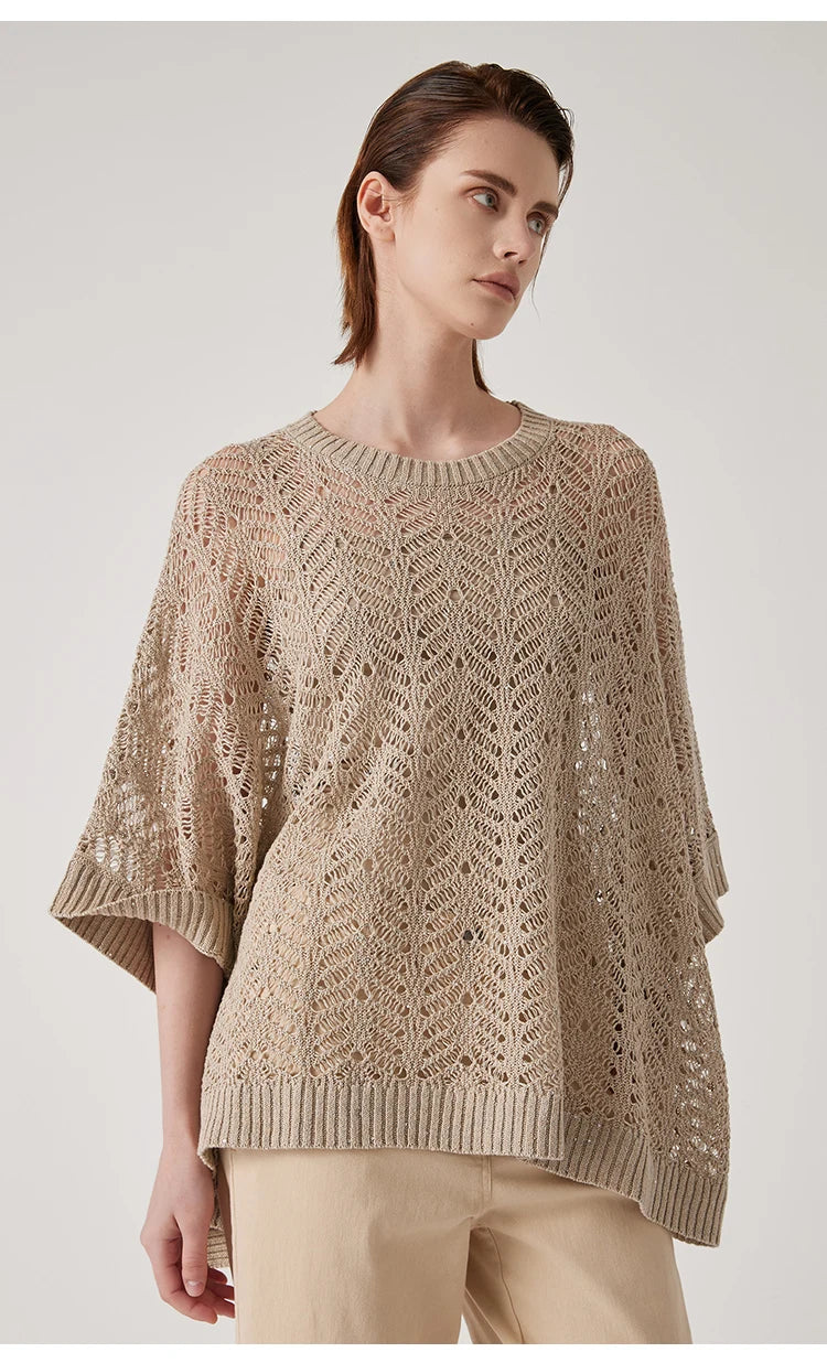 Model in Vanilla linen lace poncho turned slightly to the side, revealing airy knitwork and soft movement around the torso. From Borcelleclothes.