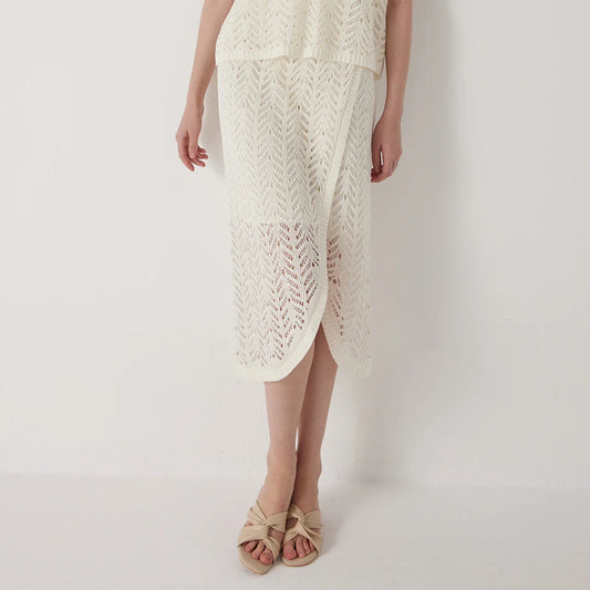 Linen lace skirt in Pearl Bush with delicate openwork pattern and soft drape, highlighting the airy texture and gentle transparency of the knit. From Borcelleclothes.