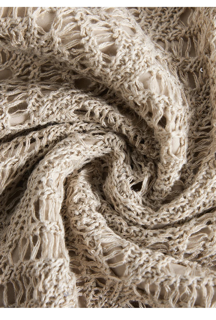 Linen lace fabric in Vanilla color twisted into a spiral, showing openwork pattern and softness. From Borcelleclothes.