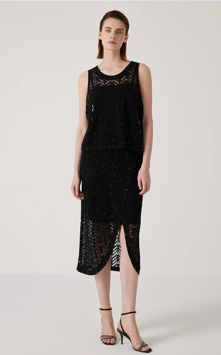 Model with arms straight, showing the full silhouette of the Onyx openwork top. From Borcelleclothes.