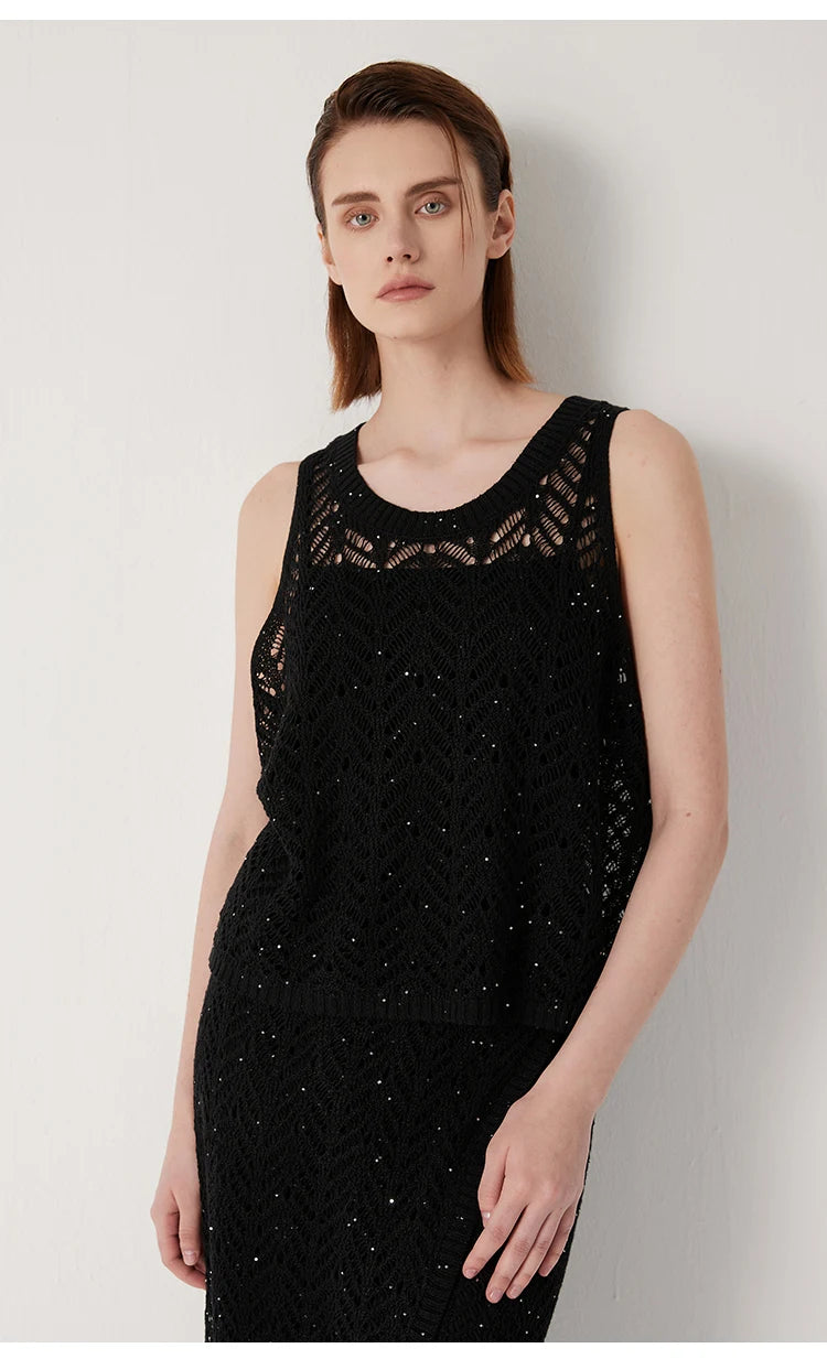 Model with hand on bent leg, capturing the relaxed elegance of the Onyx top. From Borcelleclothes.