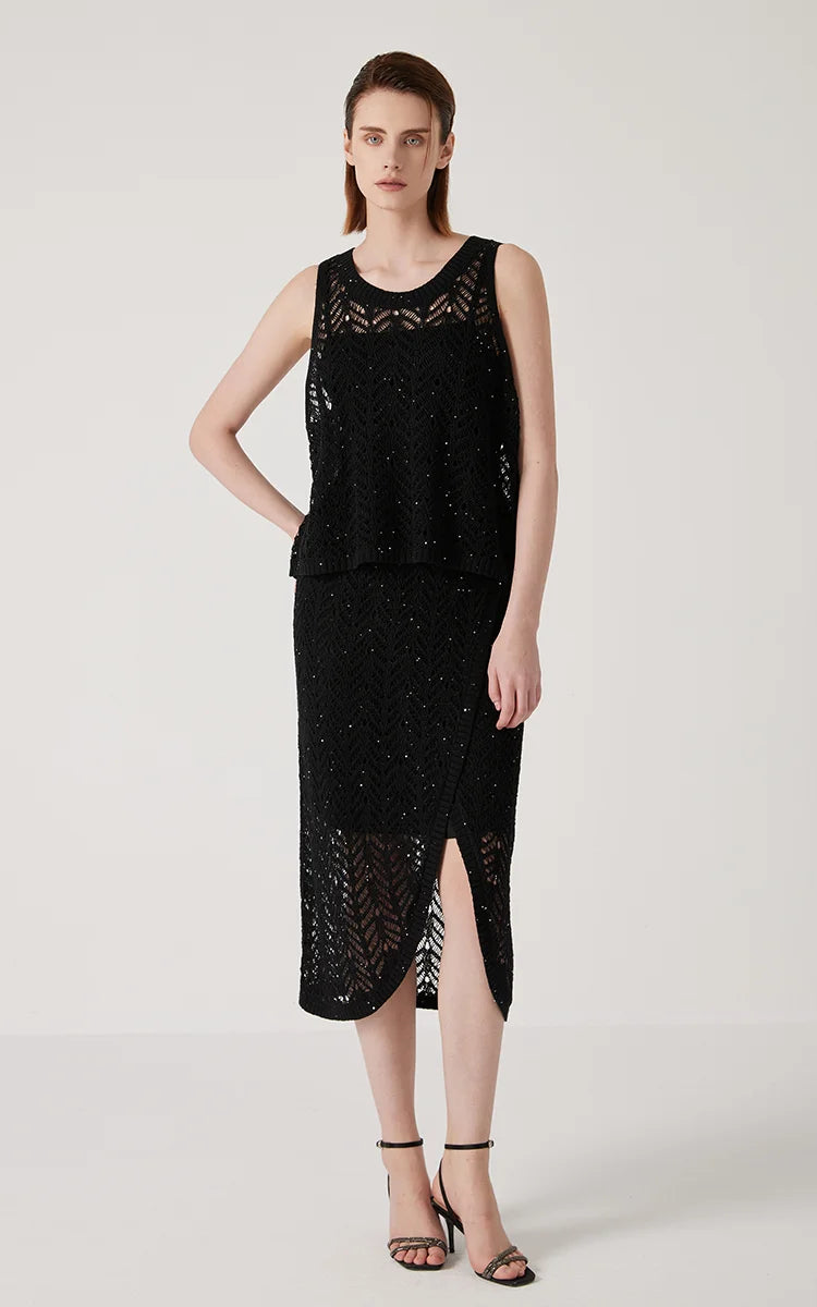 Model with hand on hip, emphasizing the shape and texture of the Onyx top. From Borcelleclothes.