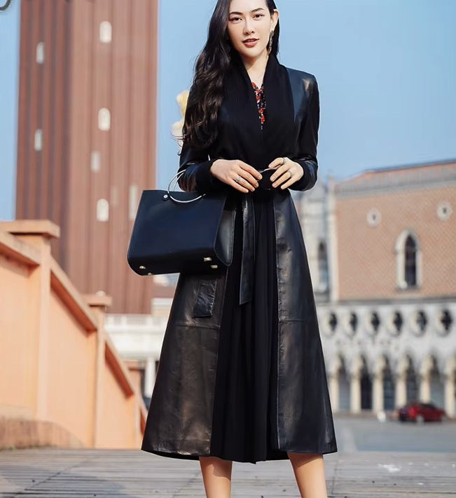 Women's Long Quilted Coat: Nightfall Embrace in Leather & Suede. Model carries a handbag, emphasizing the coat’s refined presence and timeless elegance. Borcelleclothes.