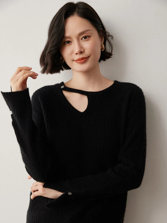 Loop neckline cashmere sweater in Onyx with model raising one arm — From Borcelleclothes.