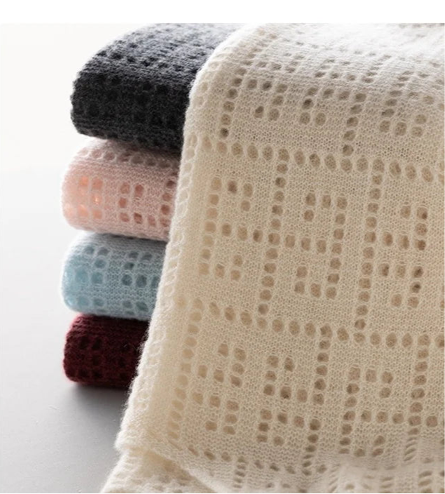 Stack of Meander cashmere tops with Pearl Bush color unfolded on top – From Borcelleclothes.