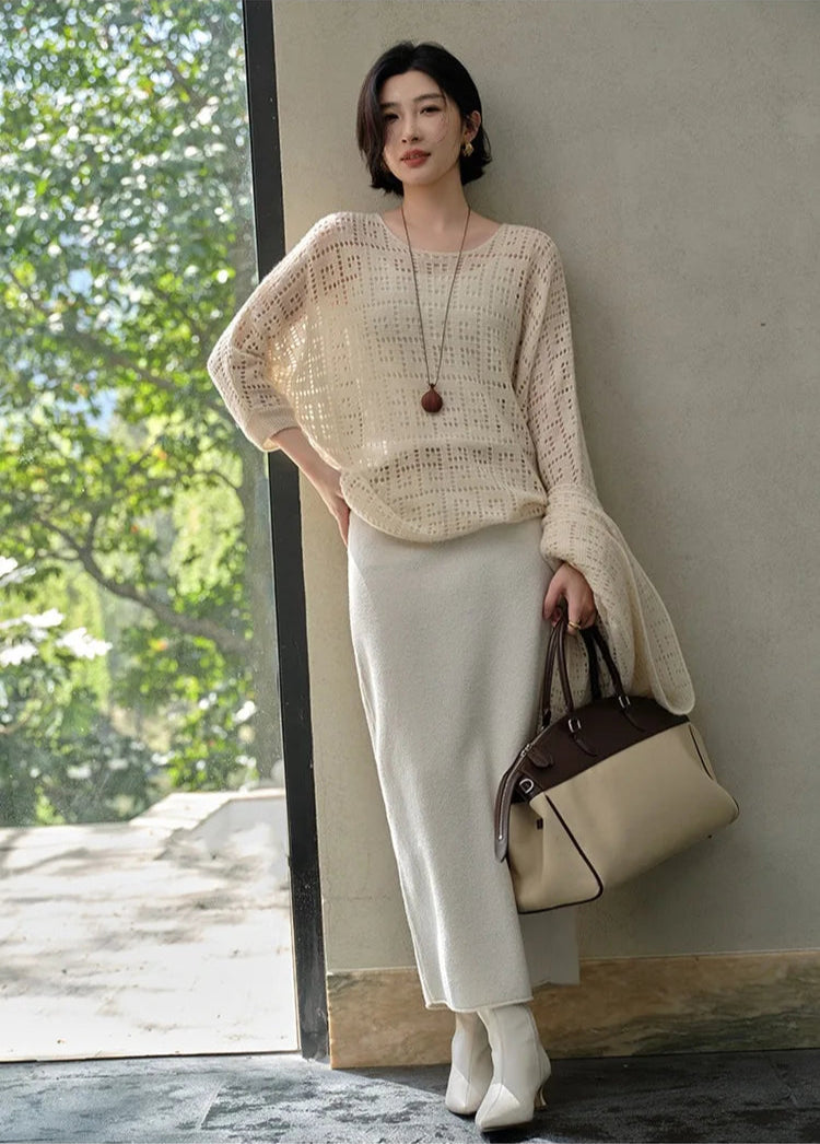 Model with crossed legs wearing the Meander openwork top – From Borcelleclothes.