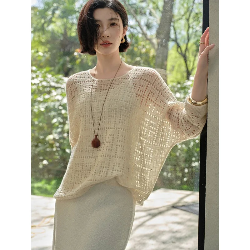 Model with raised arm revealing the batwing sleeve of the Meander cashmere top – From Borcelleclothes.