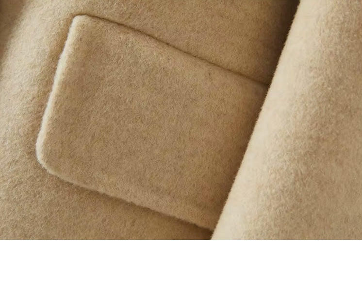 The side flap pocket on the Women's Minimalist Long Wool Coat in Vanilla, showcasing its functional and elegant design. From Borcelleclothes.