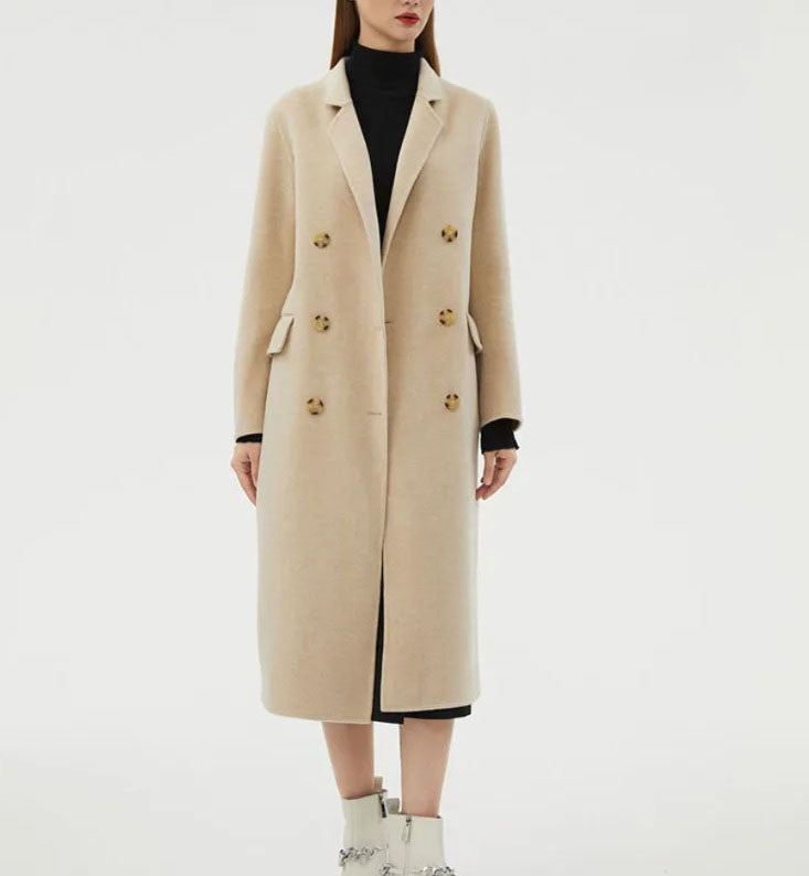 Women's Minimalist Long Wool Coat in Vanilla, featuring a double-breasted design with six buttons, notch lapels, side flap pockets, and a mid-calf length, crafted from 90% wool and 10% cashmere for timeless warmth and understated elegance. From Borcelleclothes.