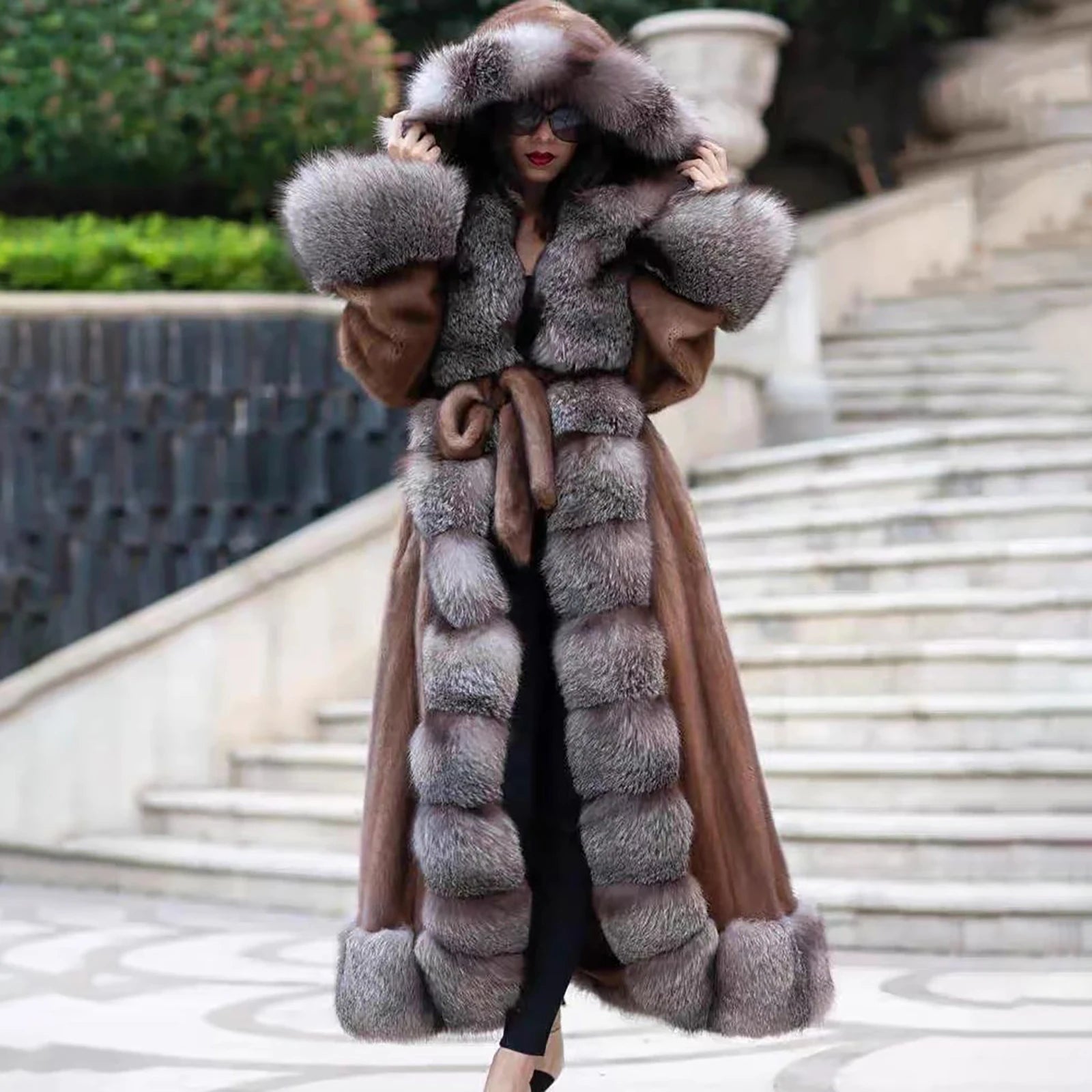 A model wearing a Women's Mink & Crystal Fox Fur Coat, gently adjusting the plush Crystal Fox collar, enhancing its enveloping presence and indulgent softness. From Borcelleclothes.