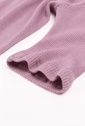 Detailed double-stitching and textured fabric on the end of the sleeve of a Women's Mock Neck Wool Top in Lily color, crafted from 100% wool for chic style and seasonal flexibility. From Borcelleclothes.