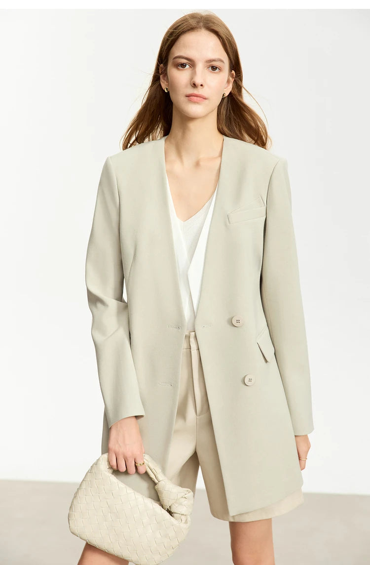Women’s Moon Mist wrap blazer, model holding a cream bag – From Borcelleclothes.