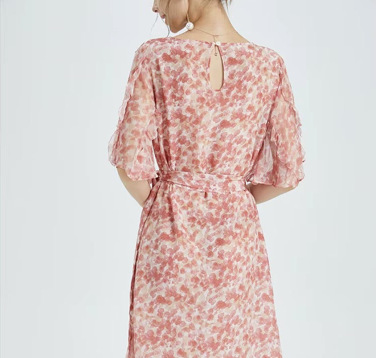 Back view of the dress revealing sheer layers and soft floral tones—delicate yet composed. From Borcelleclothes.