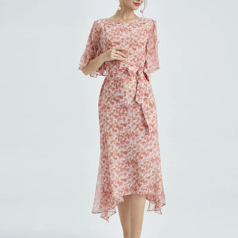 Model bending her arm while wearing the silk chiffon dress—revealing sleeve texture and flowing shape. From Borcelleclothes.