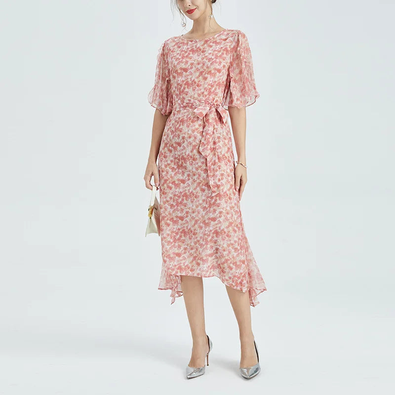 Mulberry silk chiffon dress with abstract floral print in rose tones, featuring a round neckline, matching belt, and softly flowing volume. From Borcelleclothes.