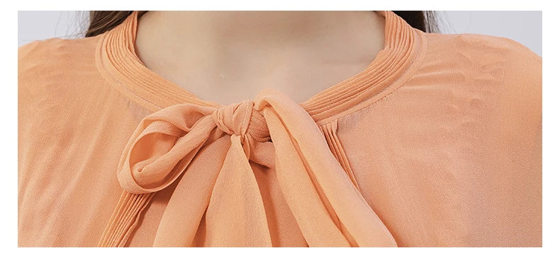 Cape tied in the front with wide ribbon bow and pintucked silk details at the neckline. From Borcelleclothes.