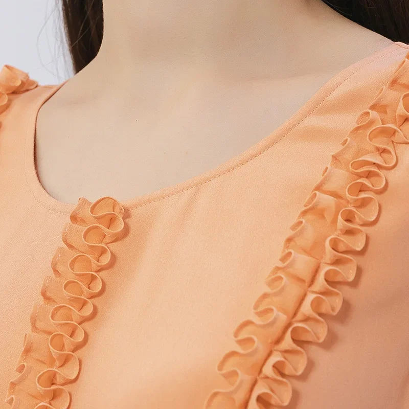 Front upper view of the silk dress in Folklore Rose, showing gathered ribbons and round neckline. From Borcelleclothes.