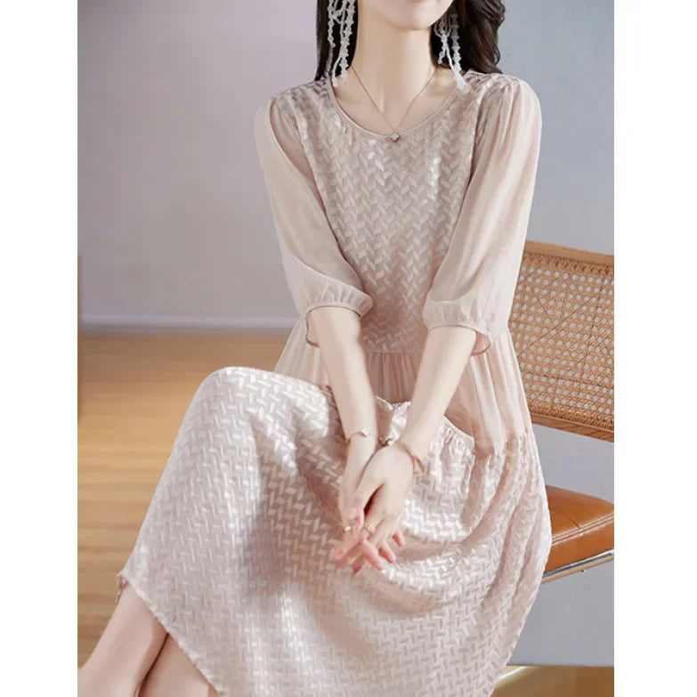 Model seated in Clam Shell georgette dress, showing the dress’s soft volume and quiet elegance in repose. From Borcelleclothes.