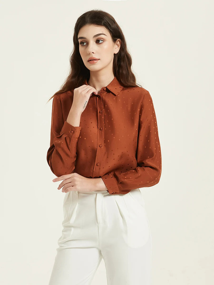 Model wearing the Women's Mulberry Silk Jacquard Dots Shirt in Sienna, looking to the side, highlighting the shirt’s sophisticated jacquard texture and subtle dot pattern. From Borcelleclothes.