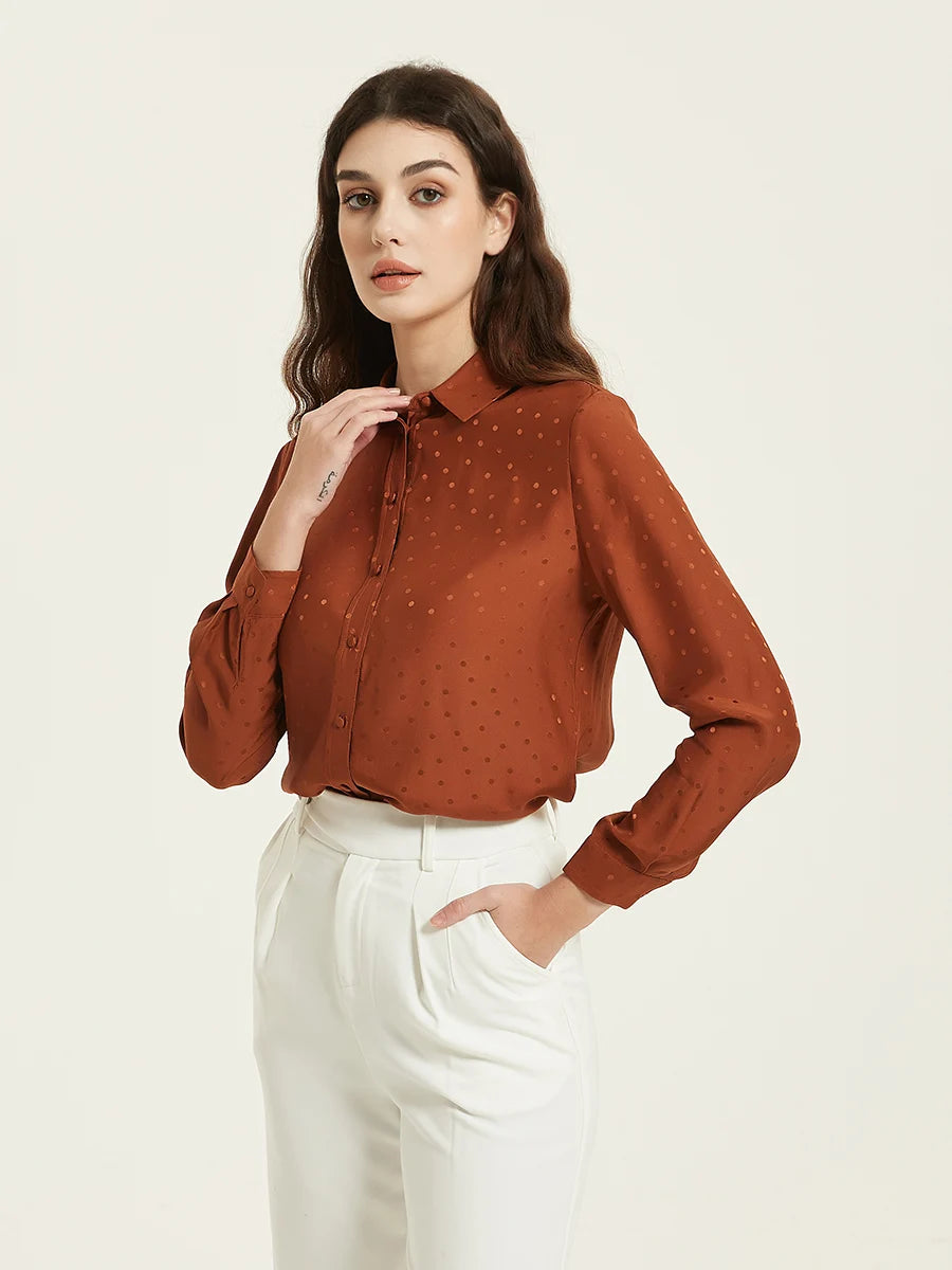 Model wearing the Women's Mulberry Silk Jacquard Dots Shirt in Sienna, touching the collar, emphasizing the shirt’s luxurious silk fabric and elegant details. From Borcelleclothes.