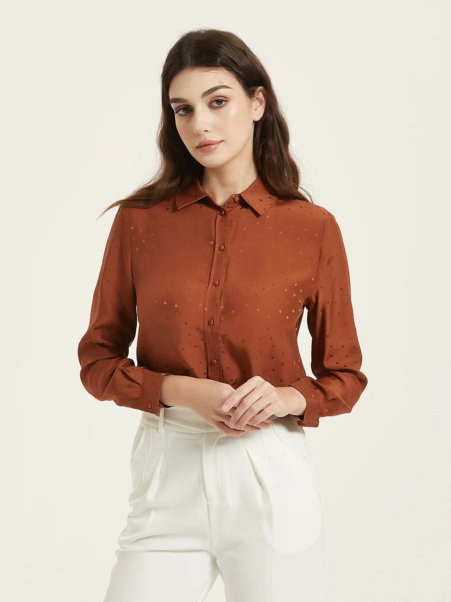 Model wearing the Women's Mulberry Silk Jacquard Dots Shirt in Sienna, gently touching her fingers, showcasing the shirt's refined elegance and dot pattern. From Borcelleclothes.