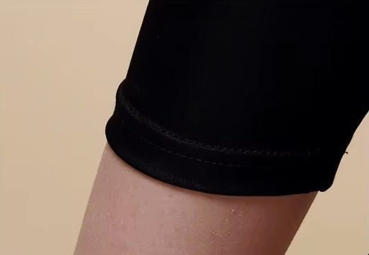 Detailed double-stitching and textured fabric on the bottom of a Women's Mulberry Silk Leggings in Onyx, crafted from 100% silk for a luxurious and elegant fit. From Borcelleclothes.