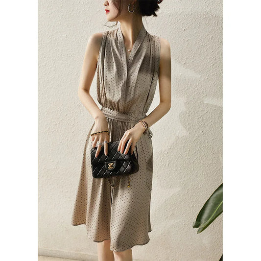 Mulberry silk polka dot dress in Almond Frost with a soft V-neckline, decorative placket, and gently flared skirt—draped with quiet elegance. From Borcelleclothes.