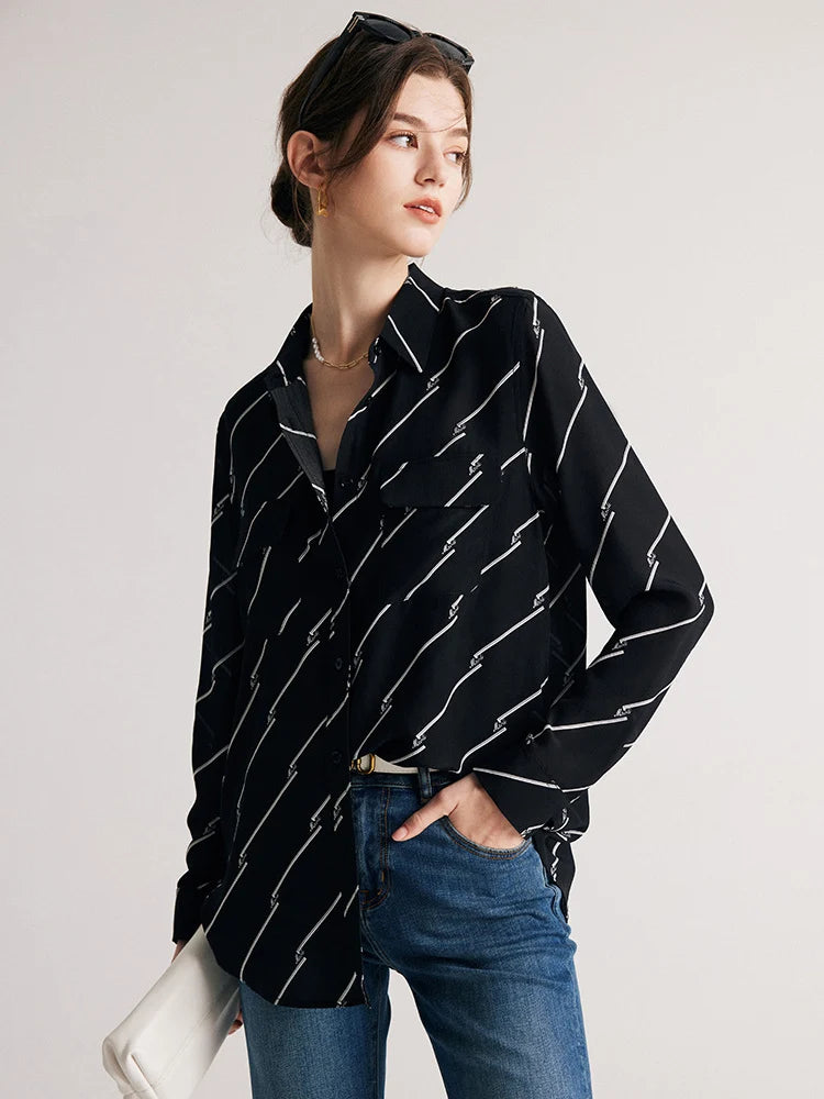 Model showcasing the relaxed fit of Women's Mulberry Silk Shirt with Black and White Diagonal Stripes by placing hand in jeans pocket. From Borcelleclothes.