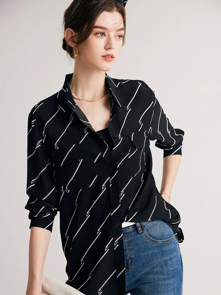 Model posing with hand on hip to emphasize the structured silhouette of Women's Mulberry Silk Shirt with Black and White Diagonal Stripes. From Borcelleclothes.