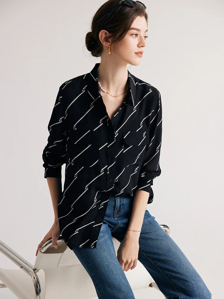 Model sitting to demonstrate the relaxed fit of Women's Mulberry Silk Shirt with Black and White Diagonal Stripes. From Borcelleclothes.